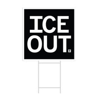 A square black yard sign with a white border and white text that says, "ICE OUT"