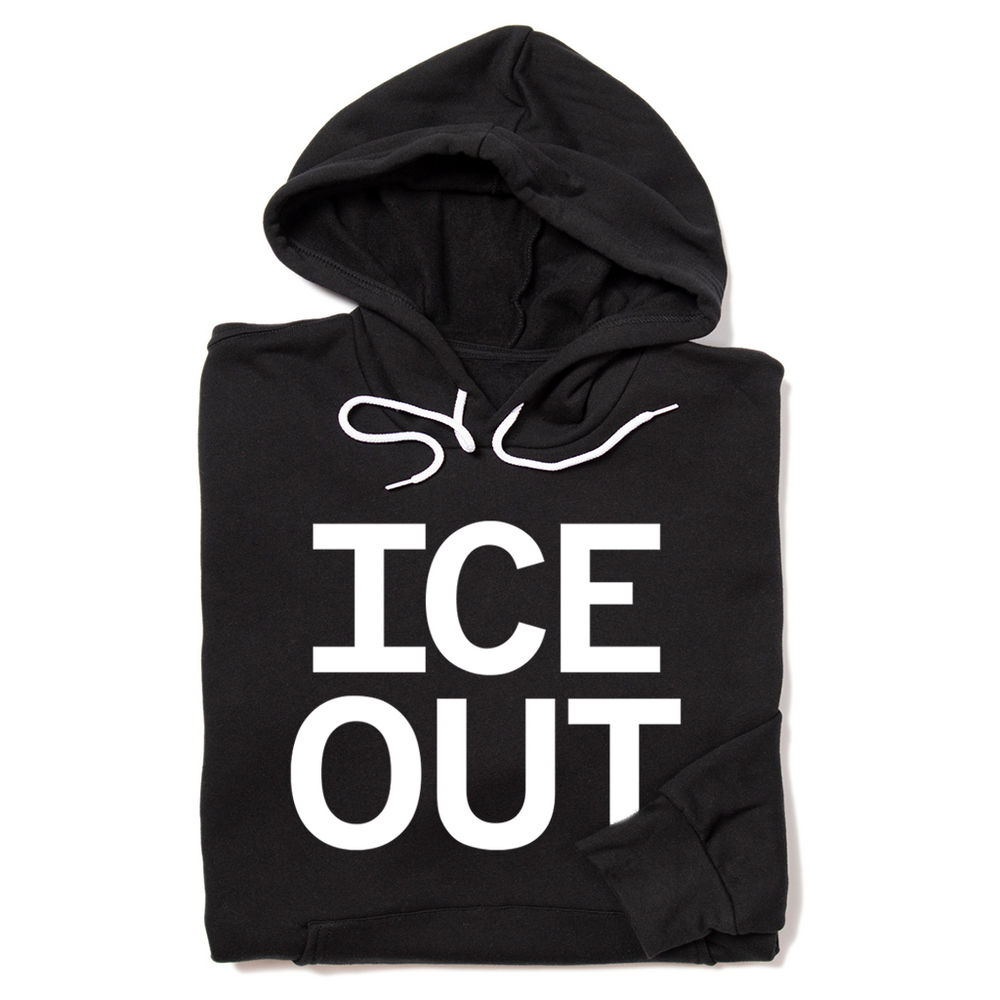 A folded black hoodie with large white print that says, "ICE OUT"