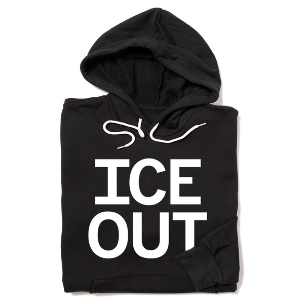A folded black hoodie with large white print that says, 