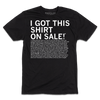 A black, union-labor T-shirt printed with the white text I GOT THIS SHIRT ON SALE! followed by a long paragraph of legal disclaimer text regarding Washington DC consumer protection laws.