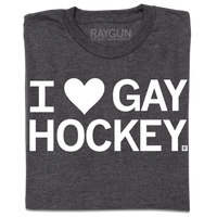 A folded charcoal t-shirt with white ink text that reads, "I heart gay hockey" where the heard is an emoji rather than spelled out.