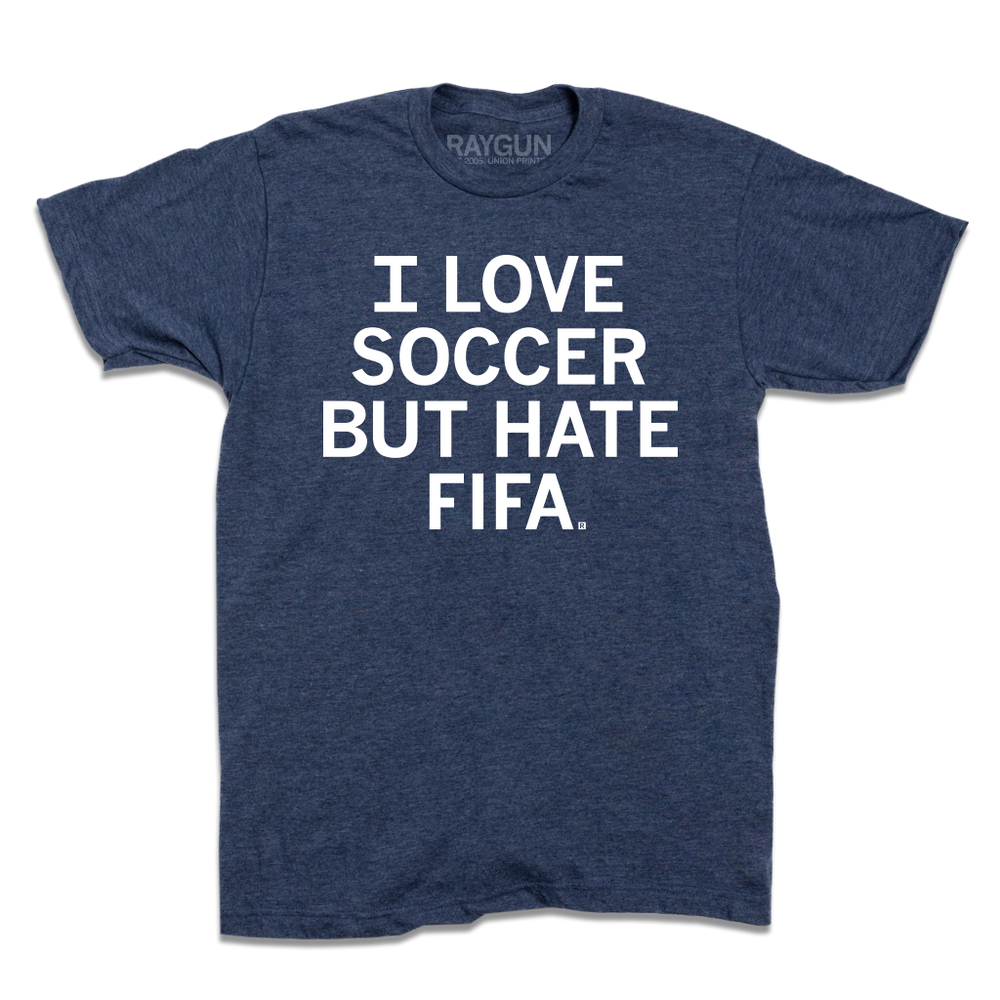 A heather denim t-shirt with centered white text that reads "I love soccer, but I hate FIFA."
