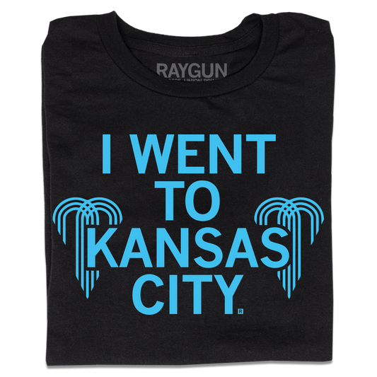 Folded black shirt with centered bright blue text that says, "I WENT TO KANSAS CITY" with water fountain logos from the city flag to either side.