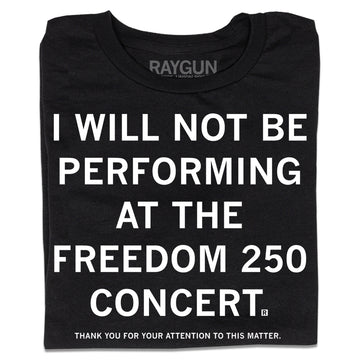 A folded black t-shirt with centered white ink text that reads "I will not be performing at the Freedom 250 Concert. Thank you for your attention to this matter."