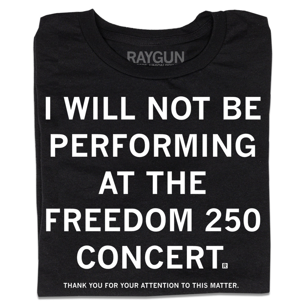 A folded black t-shirt with centered white ink text that reads "I will not be performing at the Freedom 250 Concert. Thank you for your attention to this matter."