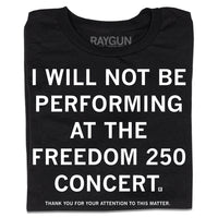 A folded black t-shirt with centered white ink text that reads "I will not be performing at the Freedom 250 Concert. Thank you for your attention to this matter."