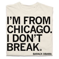 A folded off-white t-shirt with black ink text that says, ""I'm from Chicago. I don't break." - Barack Obama."