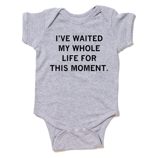 A heather grey baby onesie with centered black ink text that reads 