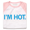 A folded white baby tee with pastel pink sleeves, shoulders, and collar. Centered bright blue text says, "I'M HOT."