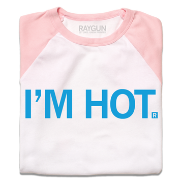 A folded white baby tee with pastel pink sleeves, shoulders, and collar. Centered bright blue text says, "I'M HOT."