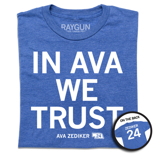 A folded heather royal blue shirt with stacked white ink text that reads "In Ava We Trust" over "Ava Zediker 24" in smaller font and a back print of "Zediker 24" styled like the back of a jersey.