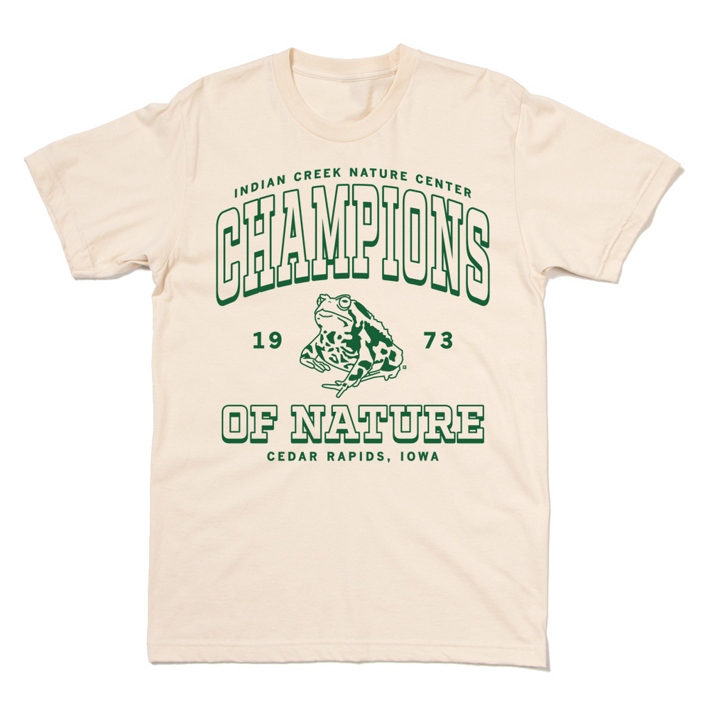 Natural colored shirt with kelly green ink that says, "Indian Creek Nature Center: Champions of Nature since 1973. Cedar Rapids, Iowa" with an illustration of a toad in the center.