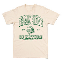 Natural colored shirt with kelly green ink that says, "Indian Creek Nature Center: Champions of Nature since 1973. Cedar Rapids, Iowa" with an illustration of a toad in the center.