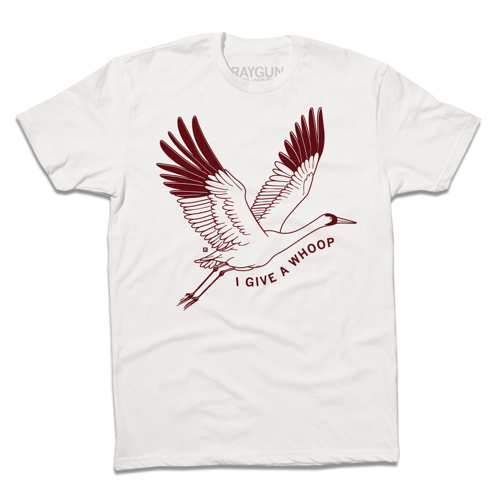 Bone color t-shirt with a maroon ink illustration of a Whooping Crane flying with the text "I Give a Whoop" underneath it.