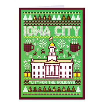 Holiday-themed RAYGUN greeting card with a green knit pattern featuring the Iowa City Old Capitol, mugs, presents, and the text City of Iowa City and Lit for the holidays.