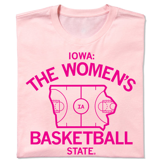 A light pink RAYGUN T-shirt featuring dark pink text that reads, Iowa: The Womens Basketball State, with an illustration of a basketball court shaped like the state of Iowa in the center.
