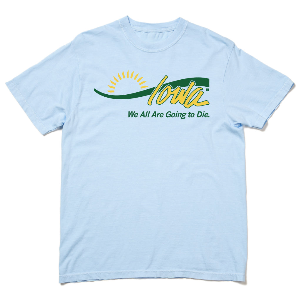 Light blue union-made t-shirt with a graphic of a yellow sun rising over the green word Iowa, with the text We All Are Going to Die printed underneath.