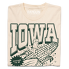 A folded cream t-shirt with dark green ink that says, "Iowa: Prepare to be aMAIZEd by all this f*cking corn" along with an illustration of a cat riding a giant ear of corn.