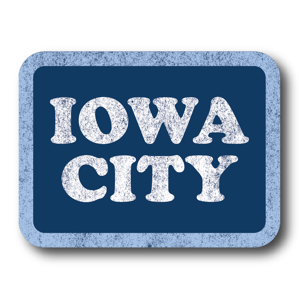 A vintage style, faded rectangle sticker with a blue background, pastel blue border, and white text that say, "IOWA CITY."