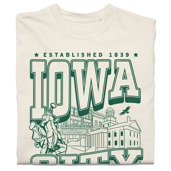 A folded heavyweight cream t-shirt with kelly green ink that says, 