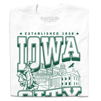 A folded white t-shirt with kelly green ink that says, "Iowa City: Established 1839. Iowa's first state Capital" with and illustrated Iowa City staples in the center, including the Englert Theater and the old Capitol Building.