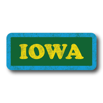 Vintage style sticker with faded print. It's a green rectangular sticker with rounded corners, a blue border and yellow text that says, "IOWA"