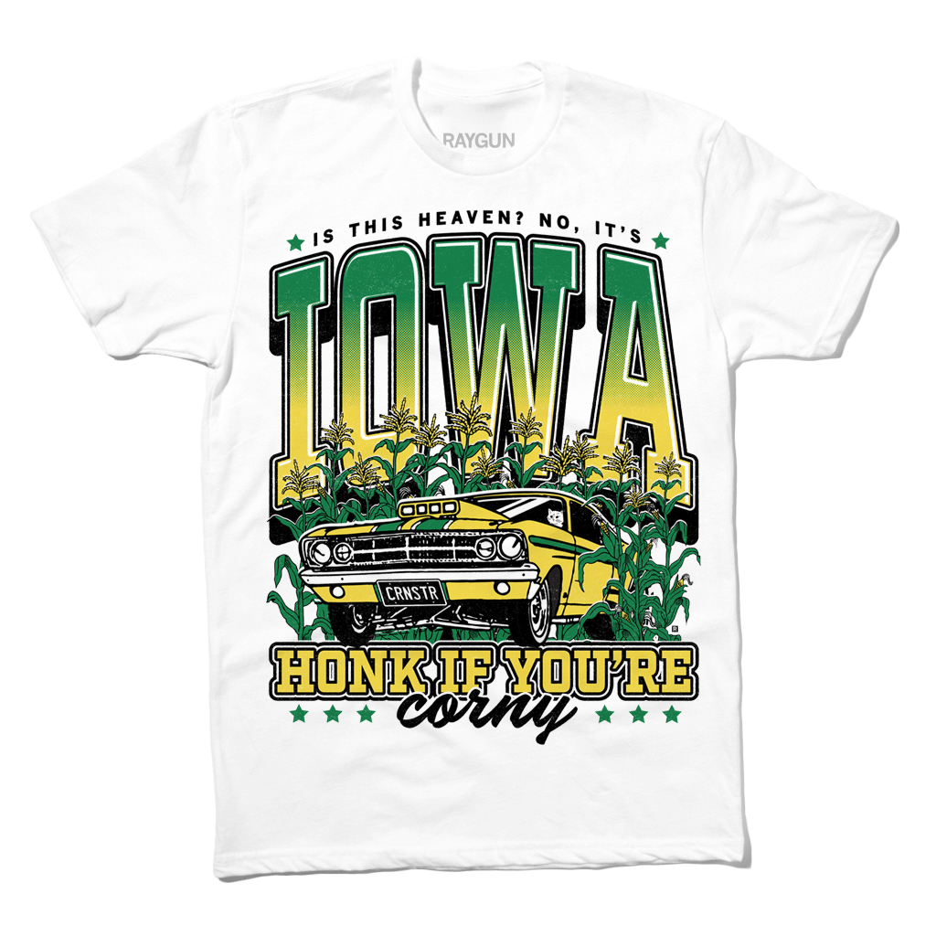 White t-shirt with green & gold ink that says, "Is this heaven? No, It's Iowa. Honk if you're corny" with a graphic of an old muscle car driving out of corn fields with a cat behind the steering wheel.