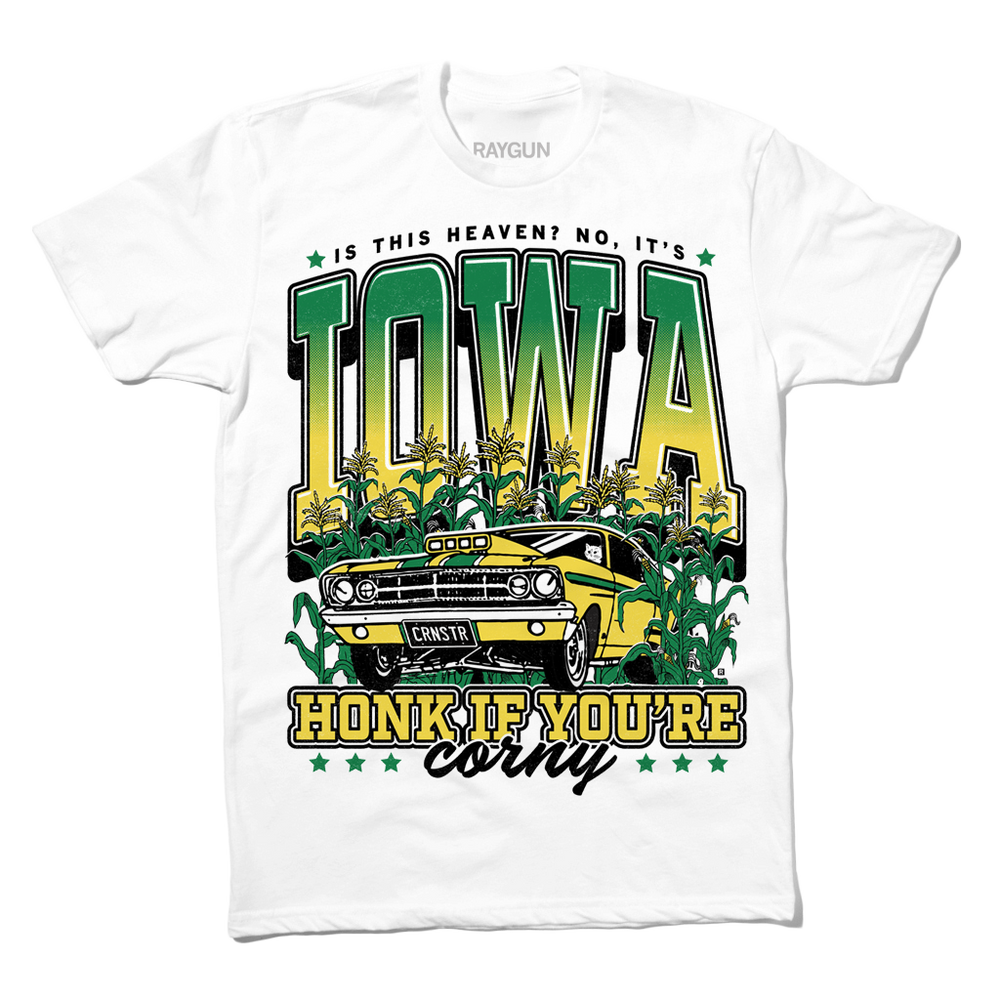 White t-shirt with green & gold ink that says, "Is this heaven? No, It's Iowa. Honk if you're corny" with a graphic of an old muscle car driving out of corn fields with a cat behind the steering wheel.