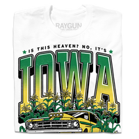 A folded white t-shirt with green & gold ink that says, "Is this heaven? No, It's Iowa. Honk if you're corny" with a graphic of an old muscle car driving out of corn fields with a cat behind the steering wheel.