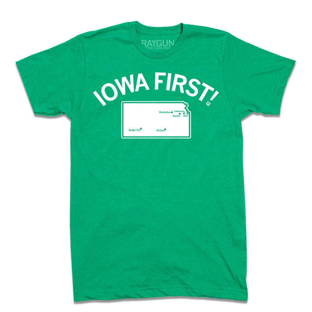 Short sleeve heather kelly green t-shirt with white ink print. Curved text near the top says, "IOWA FIRST!" above a map of Kansas with cities in KS marked on it like a map.