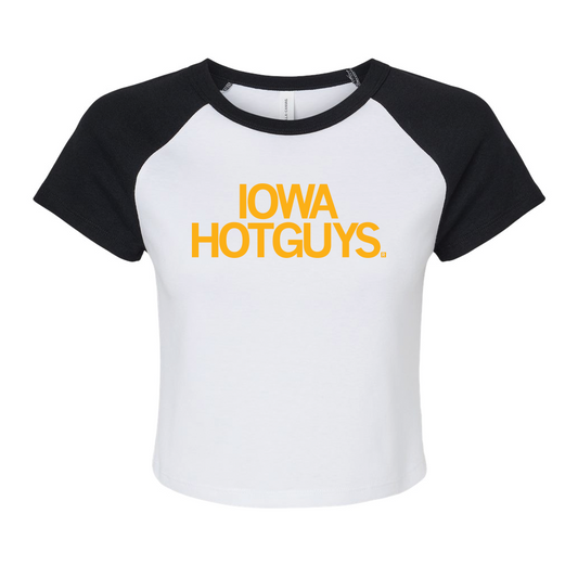 Two-tone baby tee with a white base and black collar and sleeves. Centered golden yellow text says, 'IOWA HOTGUYS."
