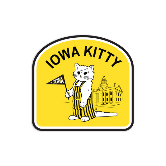 RAYGUN vinyl sticker featuring a cat in striped overalls holding an Iowa pennant in front of the Old Capitol Building, with the text IOWA KITTY.