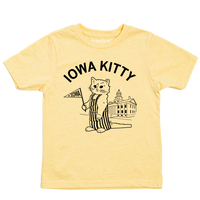 A pastel yellow kids size t-shirt that says "Iowa Kitty" in black curved font over an image of RAYGUN's cat mascot, Gary, wearing striped overalls and holding a small Iowa flag in front of the old capitol building in Iowa City.