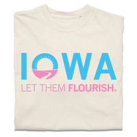 A folded ivory t-shirt with bright blue and pink print spoofing the Welcome to Iowa road signs by saying "Iowa Let Them Flourish."