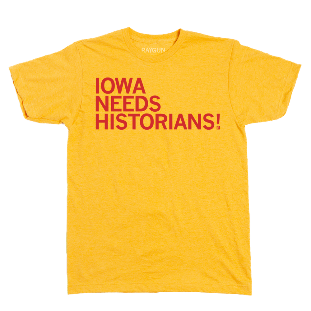 Laid flat yellow shirt with bright red text that reads "Iowa Needs Historians!"