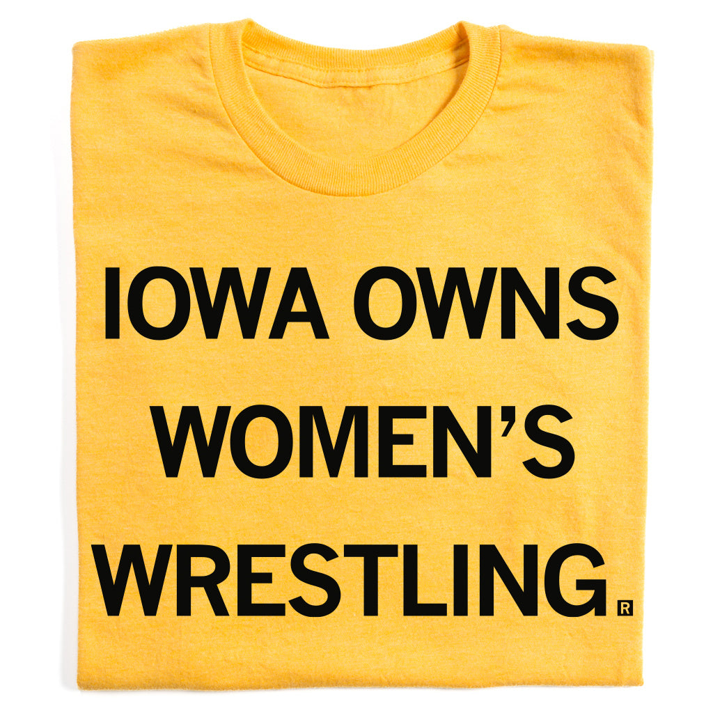 Yellow RAYGUN t-shirt with the text IOWA OWNS WOMENS WRESTLING printed in black letters.
