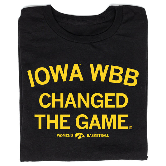 Black RAYGUN t-shirt with yellow text that reads IOWA WBB CHANGED THE GAME above an Iowa Women’s Basketball logo featuring the Hawkeyes mascot.