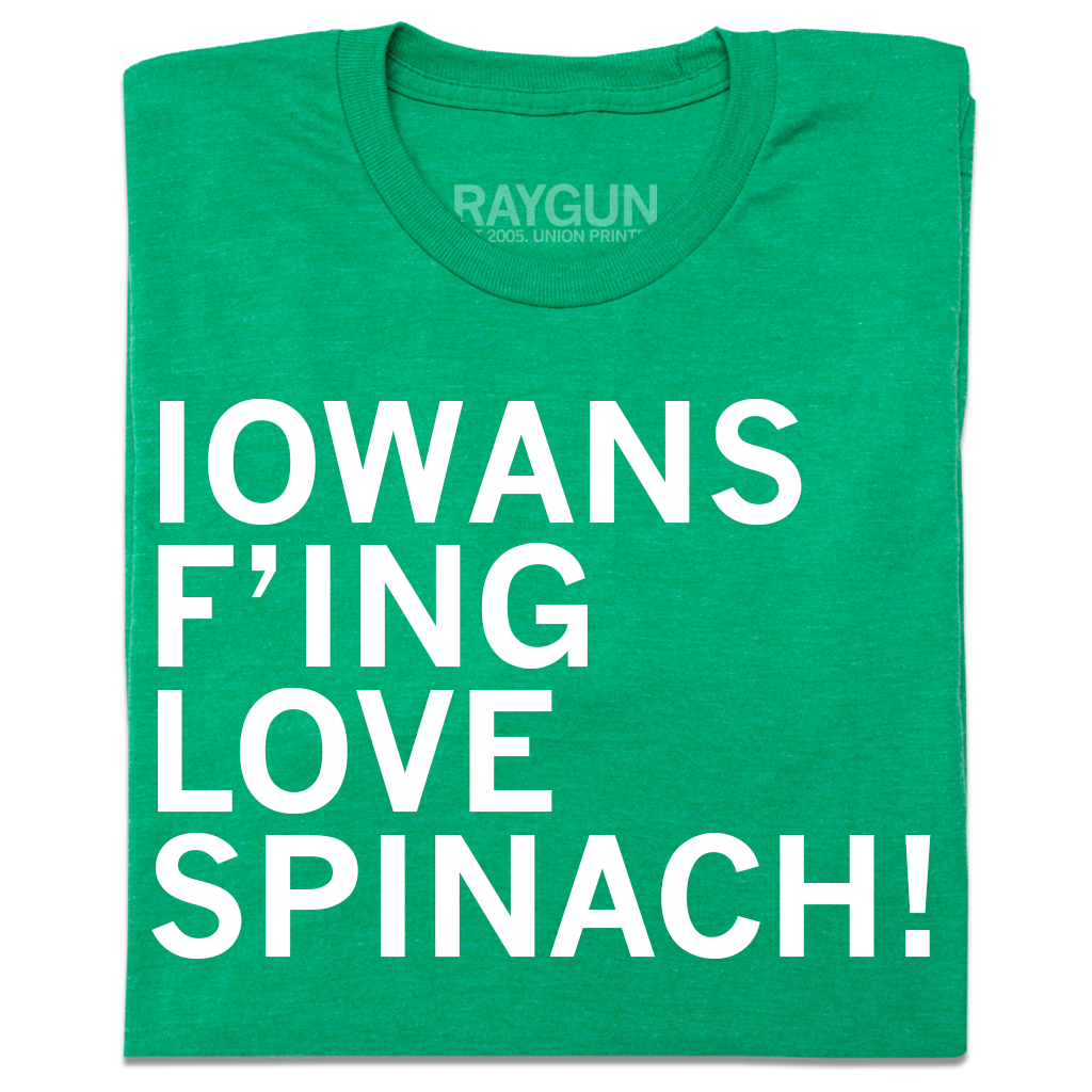 A folded heather kelly green t-shirt with left-aligned white ink text that reads "Iowans f'ing love spinach!"