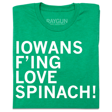 A folded heather kelly green t-shirt with left-aligned white ink text that reads "Iowans f'ing love spinach!"