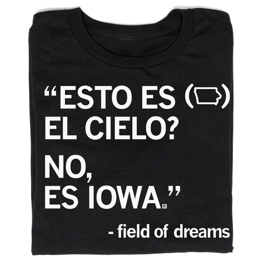 Black Raygun t-shirt with white text reading ESTO ES (Iowa shape outline) EL CIELO? NO, ES IOWA, followed by Field of Dreams at the bottom.