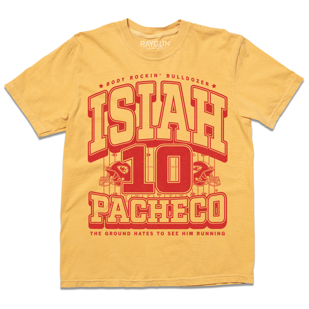 A yellow Comfort Colors t-shirt with red ink that reads "The Body Rockin' Bulldozer, Isiah Pachecho #10. The ground hates to see him running" over an illustration of a football field with a football helmet to either side.