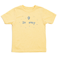 Youth sized pastel yellow t-shirt with blue print that says, "It Okay" with a smiley face above and dots scattered around. This shirt was designed by a kid taking part in a contest at our Cedar Rapids store.