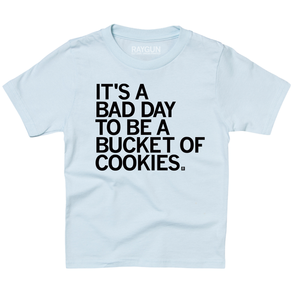 A light blue youth sized t-shirt with left aligned black text in all caps that says, 
