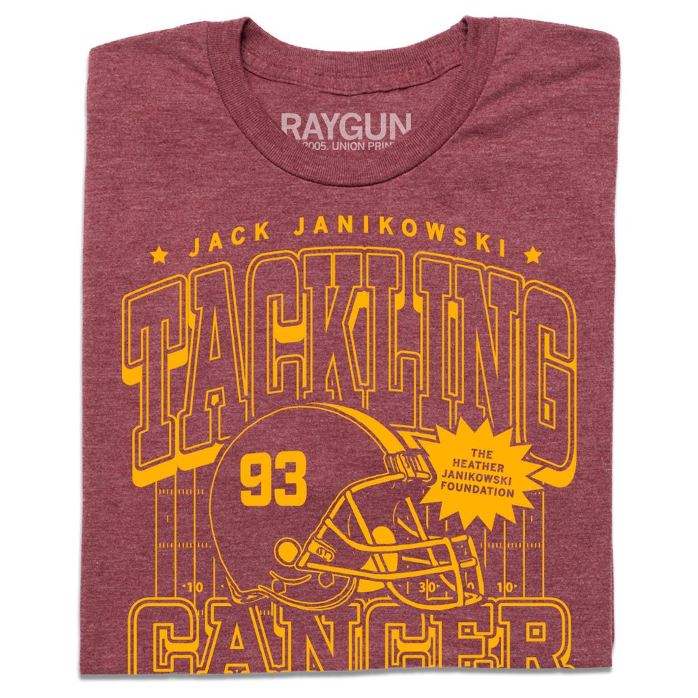 A folded heather burgundy t-shirt with gold ink laid out like a vintage sports jersey. Text reads "Jack Janikowski. Tacking cancer. The Heather Janikowski Foundation. Defensive End. Ames, Iowa."