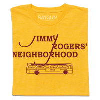 A folded heather mellow yellow shirt with cardinal ink that reads "Jimmy Rodger's Neighborhood" over an illustration of a bus with "Ames" printed on the side.