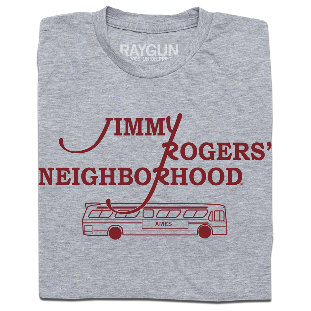 A folded heather grey shirt with cardinal ink that reads "Jimmy Rodger's Neighborhood" over an illustration of a bus with "Ames" printed on the side.