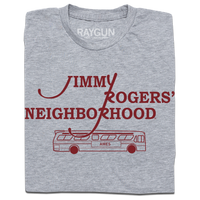 A folded heather grey shirt with cardinal ink that reads "Jimmy Rodger's Neighborhood" over an illustration of a bus with "Ames" printed on the side.