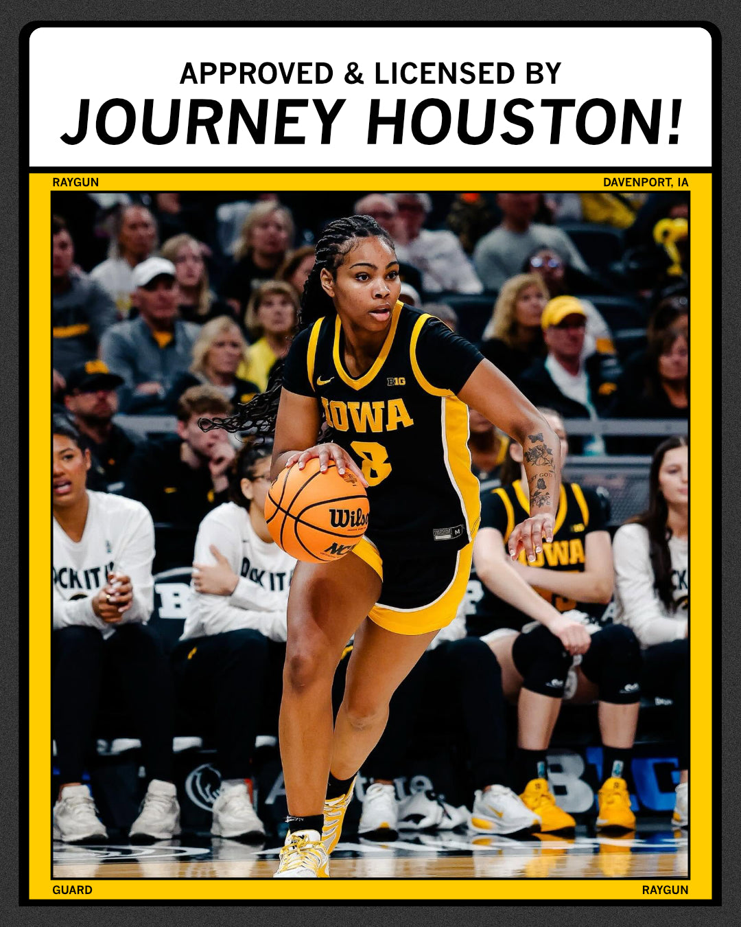 An Iowa Hawkeyes basketball player dribbles on the court, framed by a border labeled Approved & Licensed by Journey Houston! and Davenport, IA, on a charcoal T-shirt.