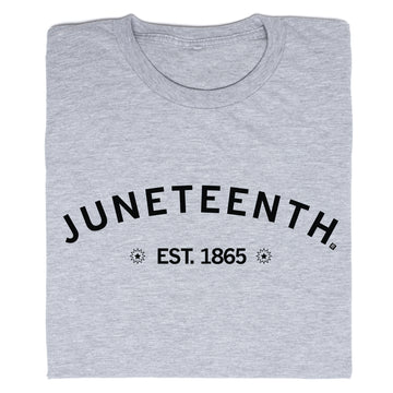 Folded grey RAYGUN crew-neck t-shirt with JUNETEENTH printed in a black arch above EST. 1865, flanked by starburst icons.