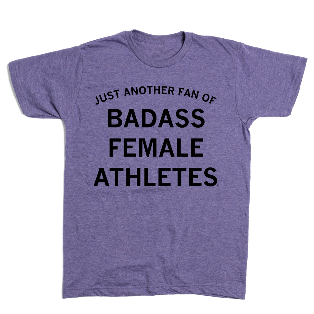 Purple short-sleeved, sweatshop-free t-shirt with the text JUST ANOTHER FAN OF BADASS FEMALE ATHLETES printed in black.